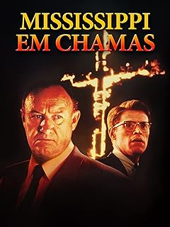 Para todos verem: Banner do filme em que há dois homens usando terno e gravata, sendo que um deles usa óculos. Ao fundo há uma cruz pegando fogo. Lê-se: "Mississippi em Chamas".