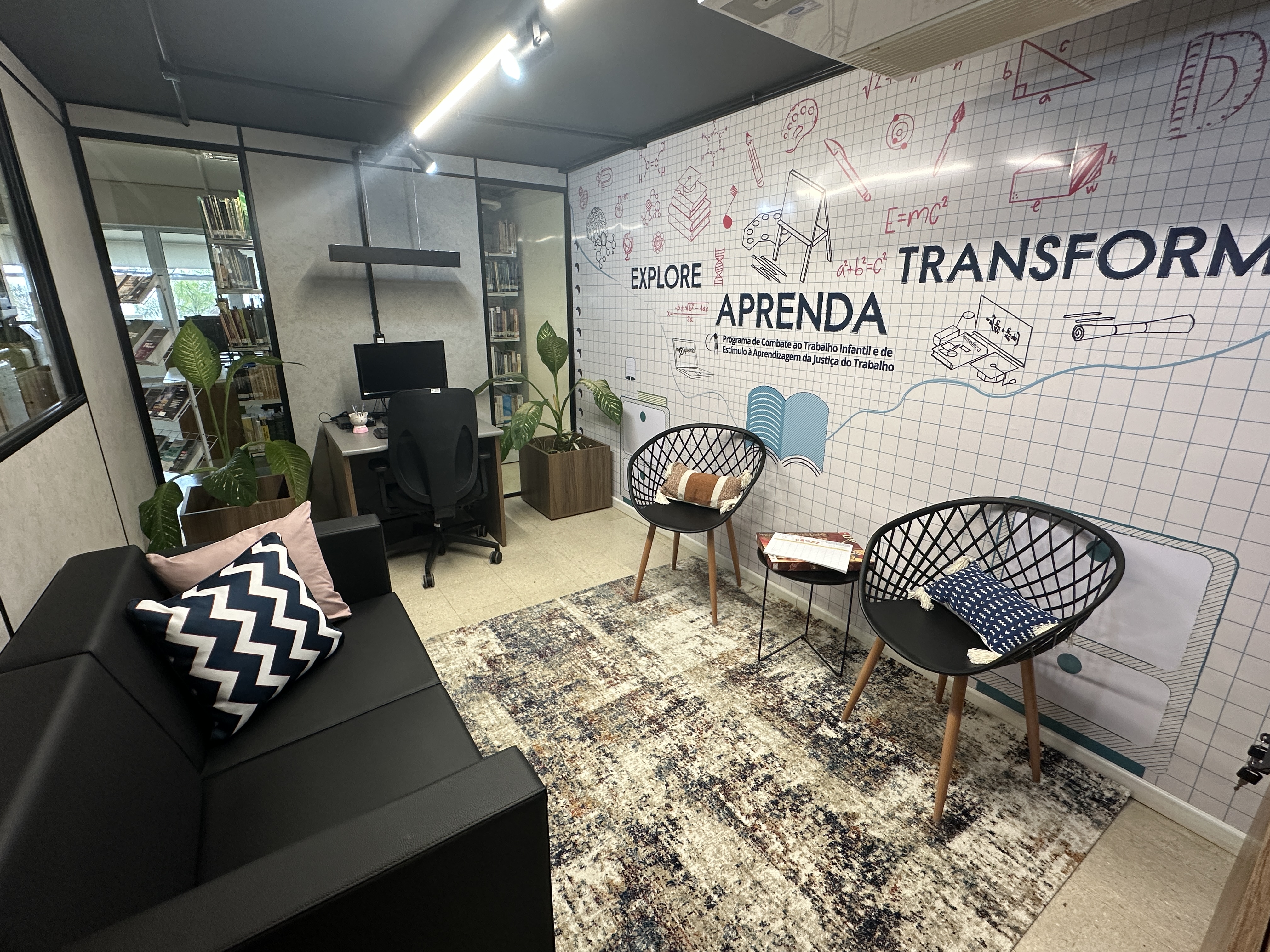 Foto de uma sala com computador, sofá e ar condicionado