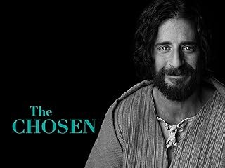 Para todos verem: Texto: "The Chosen”. Ilustração: Banner preto em que há um homem com barba e bigode.