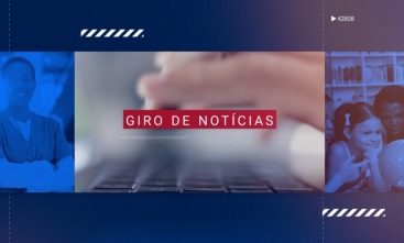 Banner com fundo azul noi qual há fotografias diversas. Na imagem central está uma mão sobre um teclado. Em um fundo vermelho está escrito "Giro de Notícias".