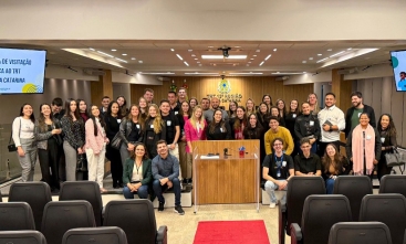 Grupo de pessoas posando para foto em frente ao plenário do Tribunal