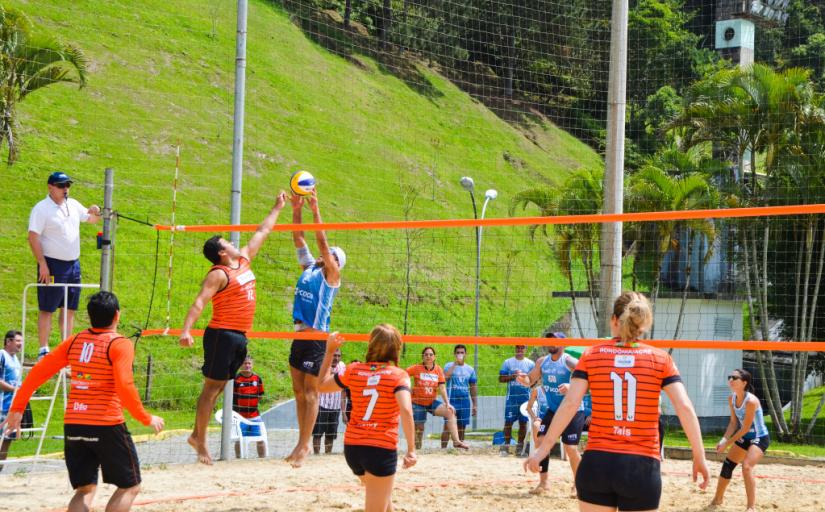 Equipe de atletas jogando vôlei de praia