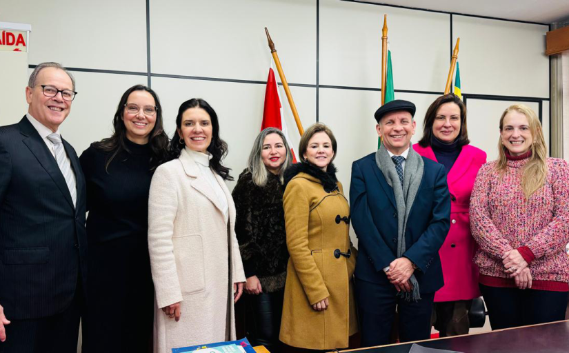 Foto de um grupo de oito pessoas, sendo dois homens e seis mulheres, em pé.