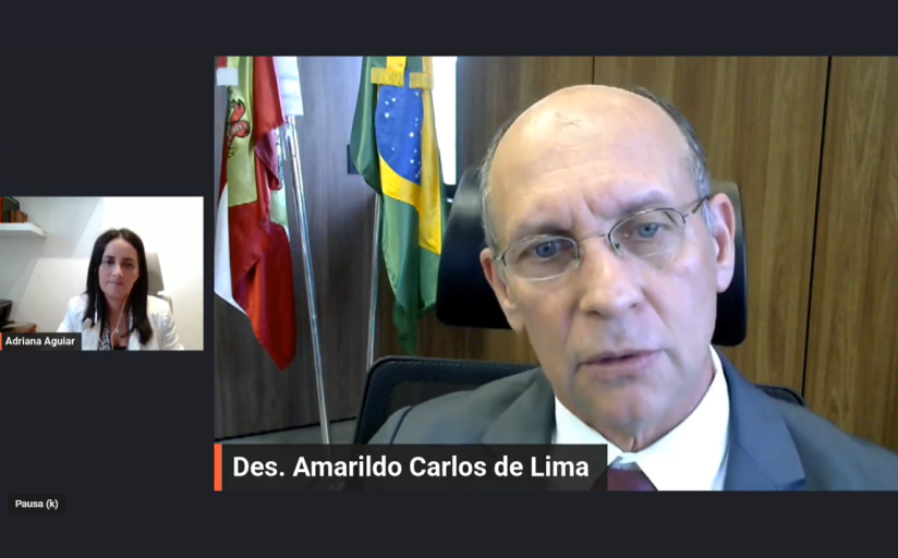 Tela de uma conversa em vídeo, com um homem de óculos e uma mulher de cabelos escuros
