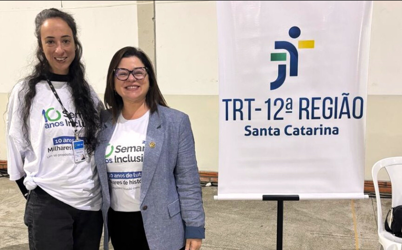 Foto de duas mulheres de cabelos castanhos em pé, posando e sorrindo