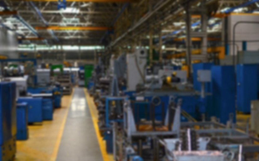 Fotografia ilustrativa de um ambiente de fábrica industrial desfocado