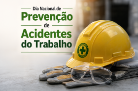 Dia Nacional de Prevenção de Acidentes de Trabalho. Imagem de um capacete amarelo sobre uma luva e um óculos de segurança do lado