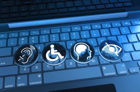 Teclas de um notebook com quatro símbolos de acessibilidade: audição, mobilidade, deficiência intelectual e deficiência visual.